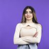 Portrait of young confident girl crossed her arms and looking at the camera. High quality photo