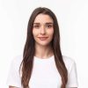 Close-up portrait of beautiful young woman, modern girl with long chestnut hair and no pimples, standing simple shirt and smiling camera, positive friendly expression, white background.