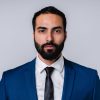 Serious successful Arabian businessman in formal attire isolated over grey background
